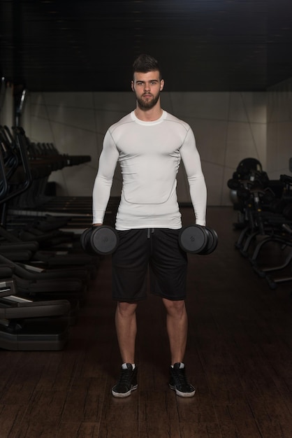 Young Man Exercise Biceps With Dumbbells  Dumbbell Concentration Curls