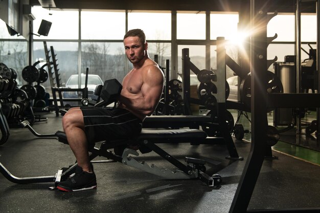 Young Man Exercise Biceps With Dumbbells