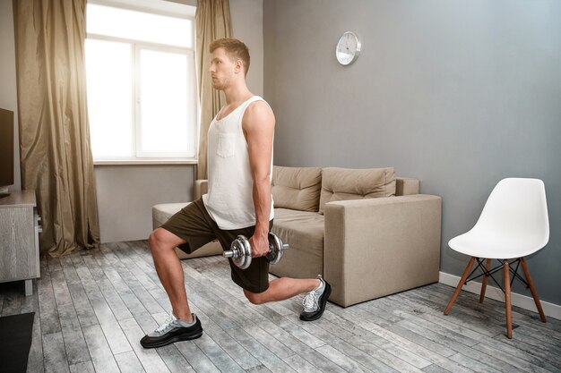 Young man exercises at home