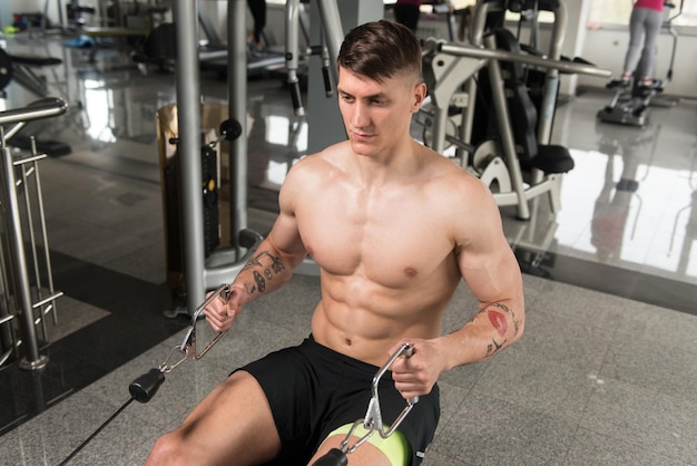 Young Man Exercising Back In The Gym