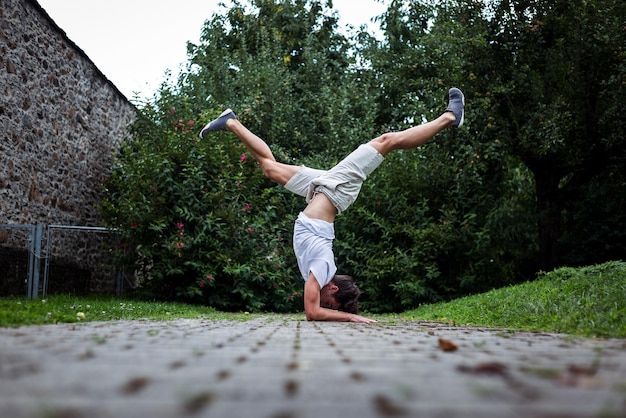 Young man exercising on footpath