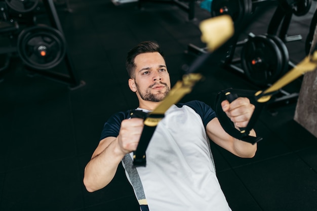 Young man exercising at gym.