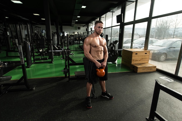 Young Man Exercising With Kettle Bell