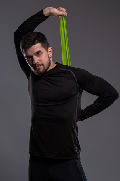 Young man exercising with resistance elastic band