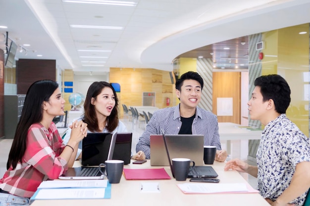 Young man explains financial report in the office