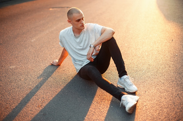 Young man in a fashionable outfit on the road