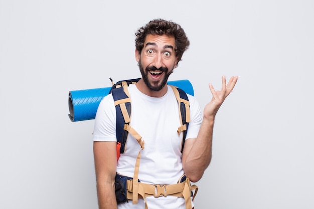 Young man feeling happy, surprised and cheerful, smiling with positive attitude, realizing a solution or idea