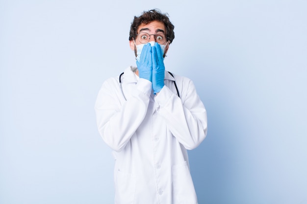 Young man feeling worried, upset and scared, covering mouth with hands, looking anxious and having messed up. coronavirus concept