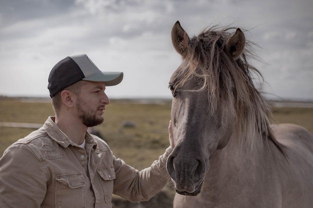 Young man in field with horse