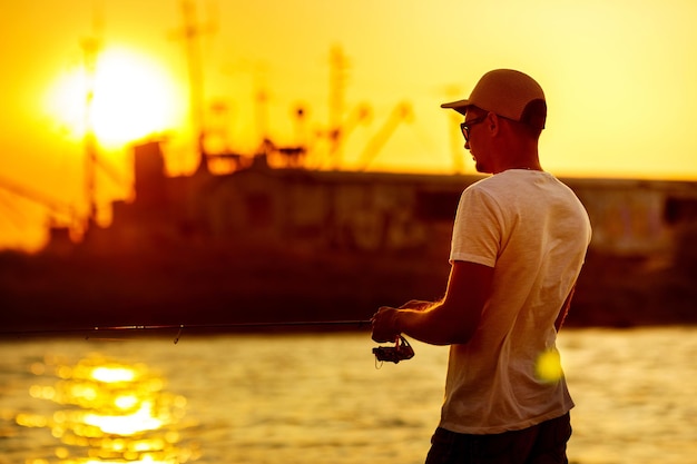 Young man fishing at sea person