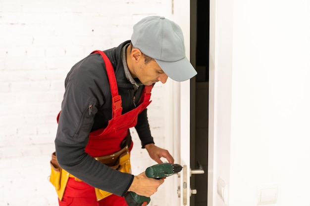 Young man fixing the door with screwdriver.