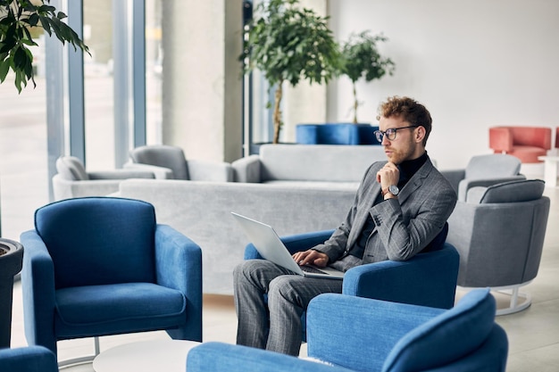 Young man in formal using laptop while waiting for a job interview People and recruitment concept