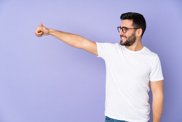 Young man gesturing with thumbs up