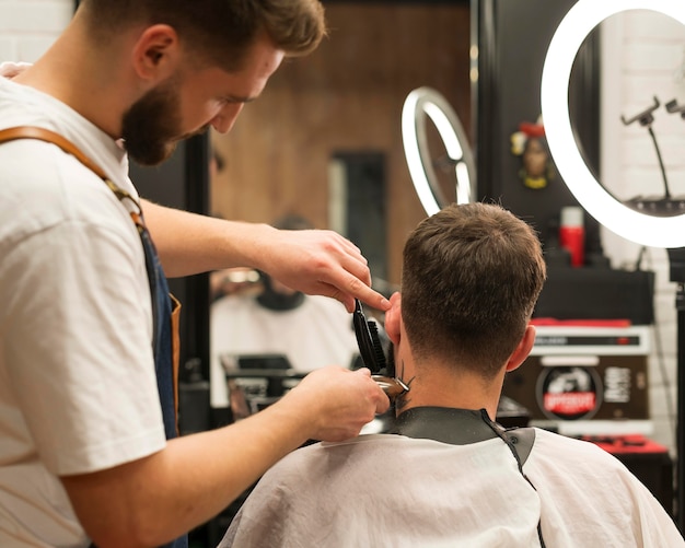 Young man getting a new haircut at the barber