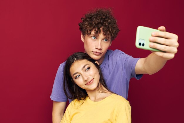 Young man and girl take a selfie posing hug Youth style