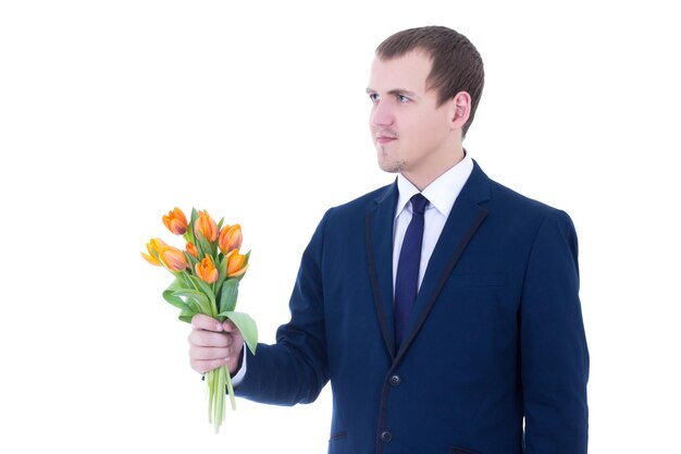 Young man giving bouquet of tulips isolated on white background