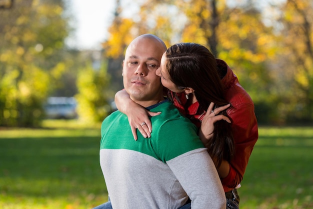 Young Man Giving His Girlfriend A Piggyback Ride