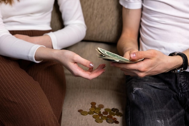 Young man giving money to woman Cash dollars