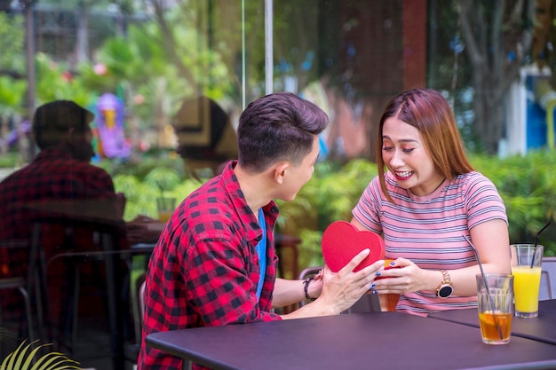 Young man giving present to his girlfriend