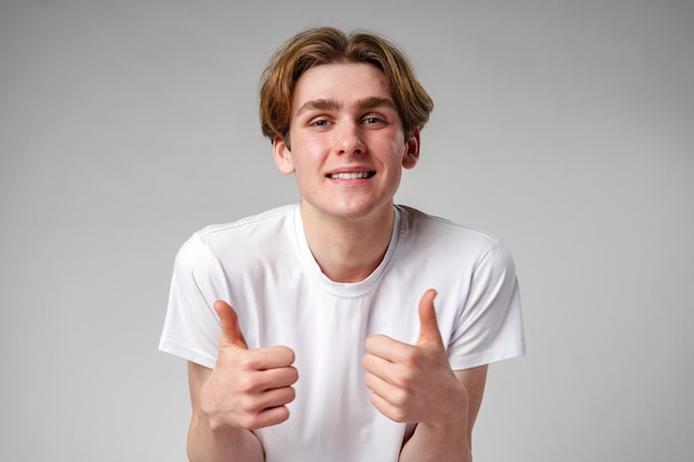 Young man giving thumbs up sign