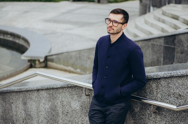 a young man in glasses near the railing