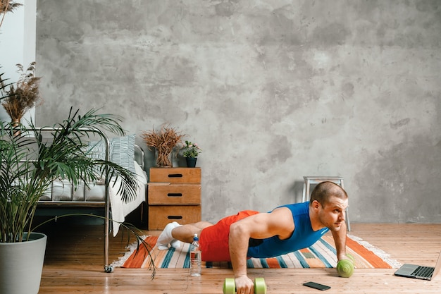 The young man goes in for sports at home