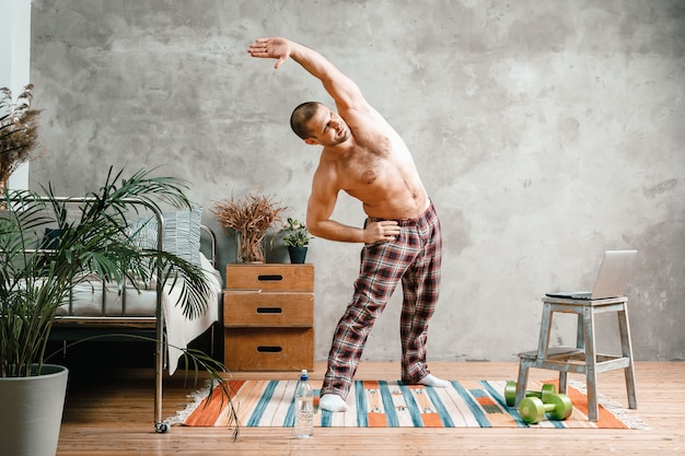 The young man goes in for sports at home