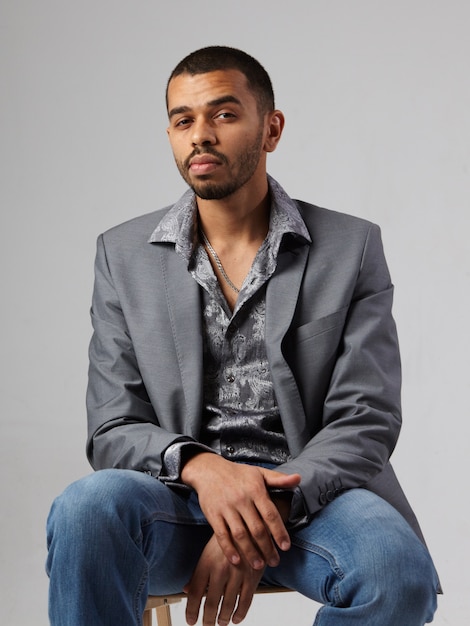 Young man in gray blazer and jeans