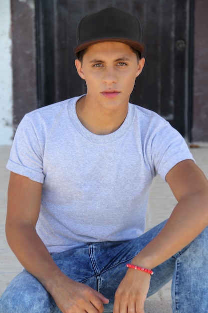 young man in gray tshirt and black cap