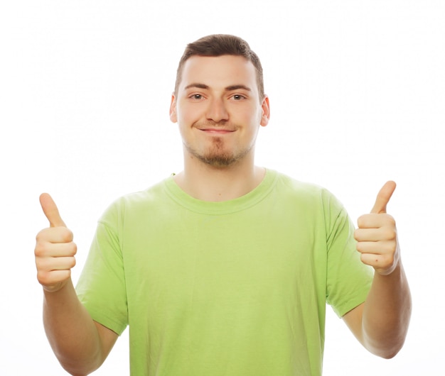 Young man in green shirt  showing thumbs up.