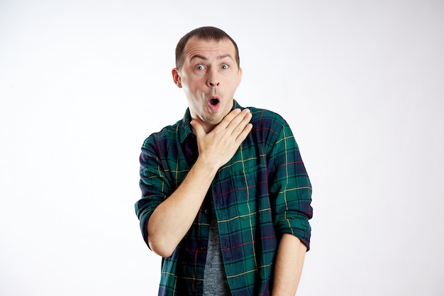 Young man in a green shirt on white background