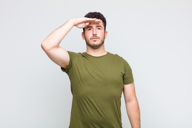 Young man greeting the camera with a military salute in an act of honor and patriotism, showing respect