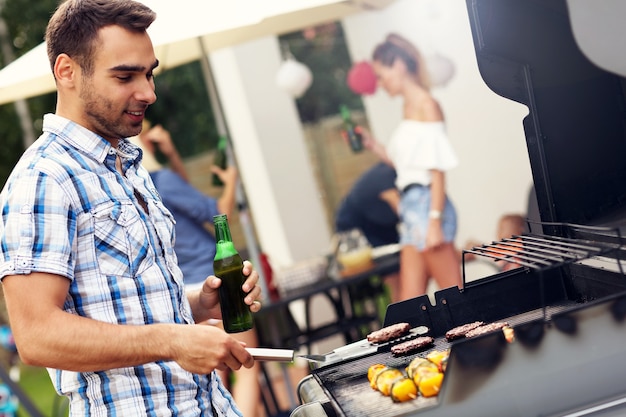 young man grilling food