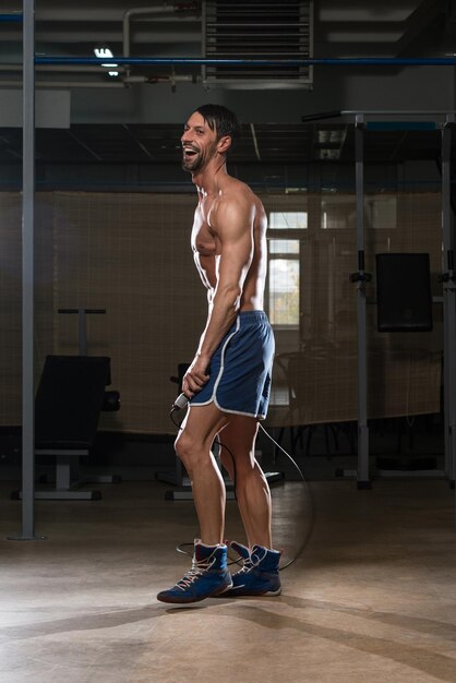 Young Man In Gym Is Jumping Rope