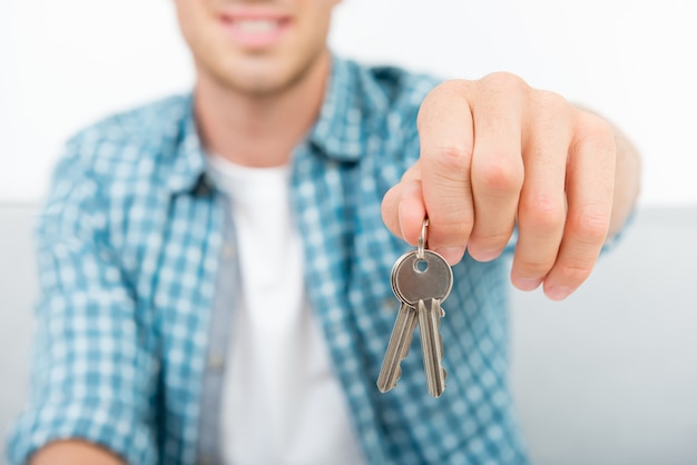 Young man handing house keys over