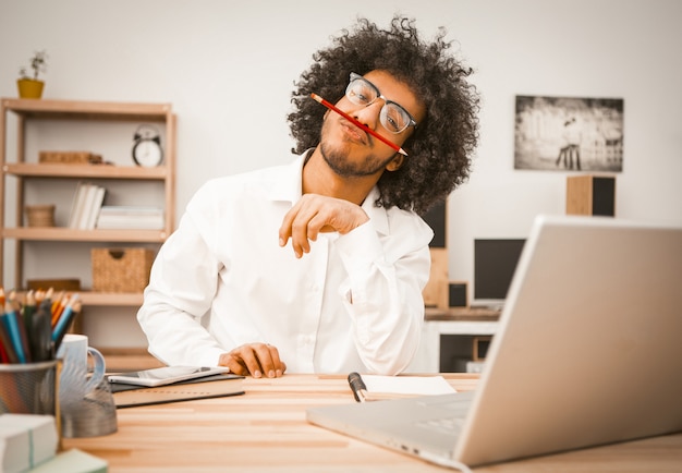 Young man has fun working laptop at Home interior.