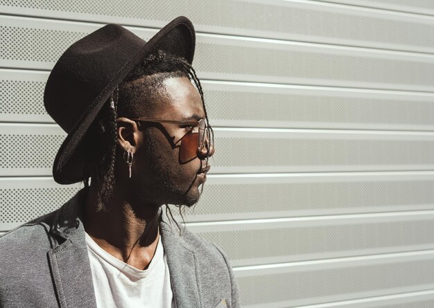 Foto giovane con il cappello che guarda da un'altra parte