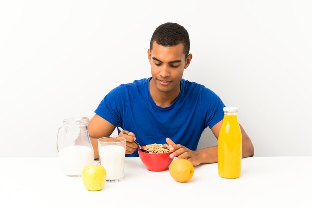 Young man having breakfast in a table