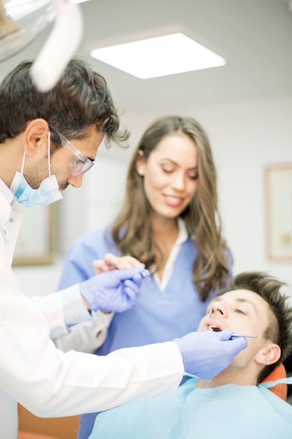 Young man having dental chekup at dentist office