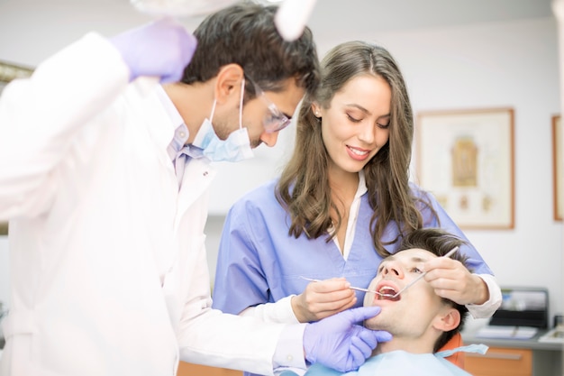 Young man having dental chekup at dentist office