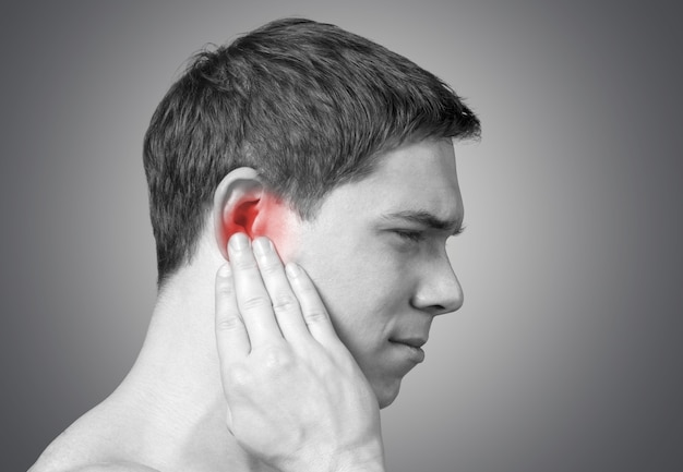 Young man having ear pain