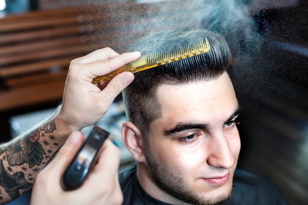 Young man having hair cutted