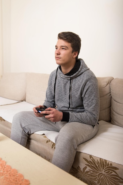 young man having happy time playing video games at home
