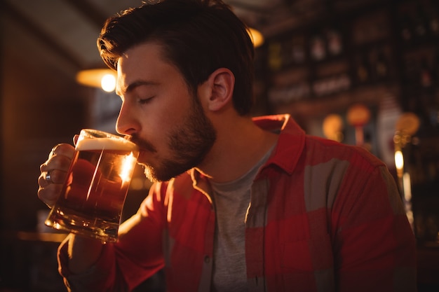 Young man having mug of beer