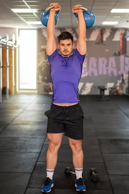 Young Man In His 20s Doing Kettlebell Exercises In The Gym