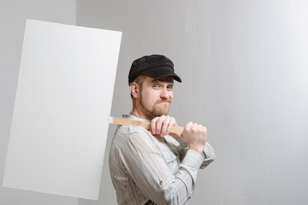 young man holding a blank banner