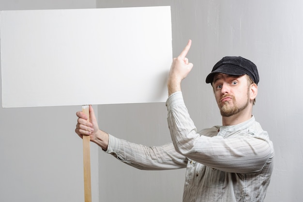 young man holding a blank banner