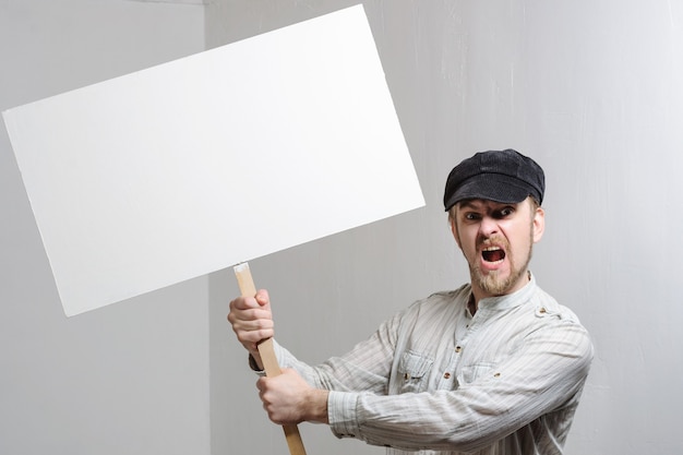 Young man holding a blank banner