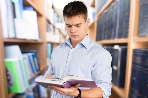 Young Man Holding Book On  Background