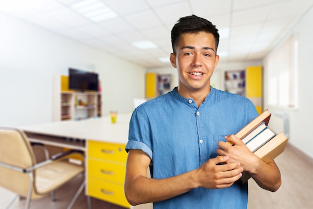 Young man holding books